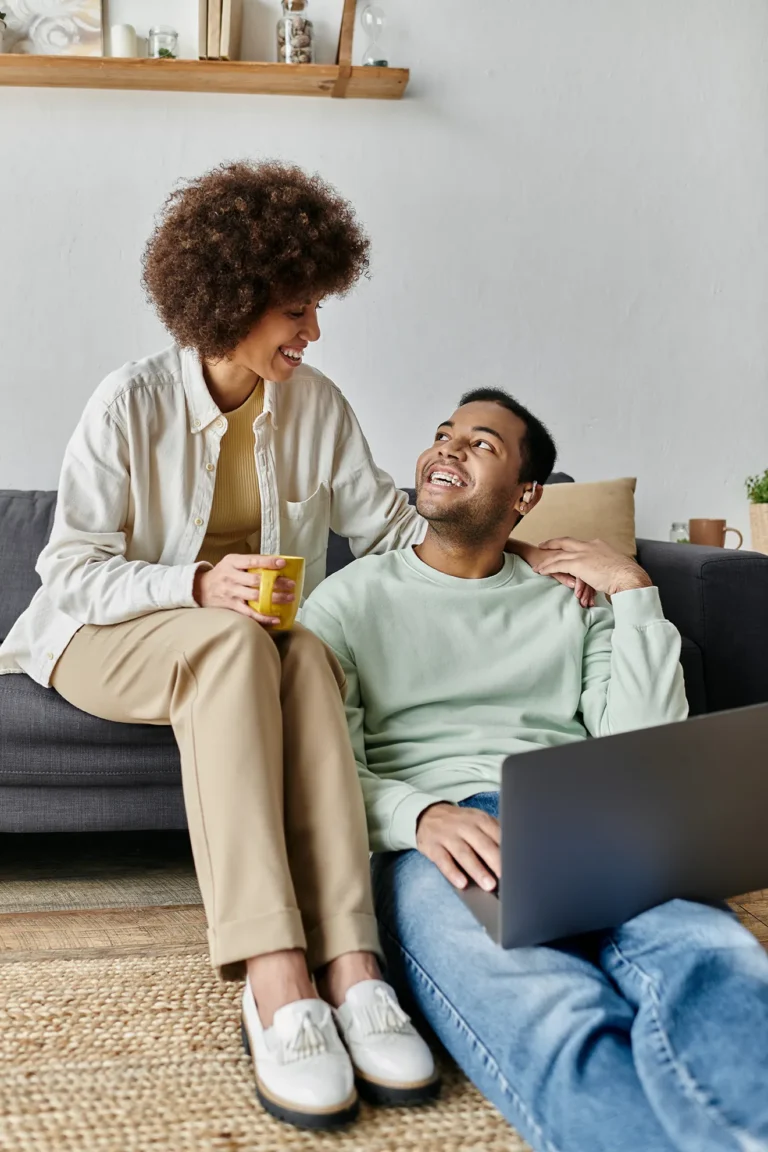 Relaxed couple at home smiling at each other during a calm moment together