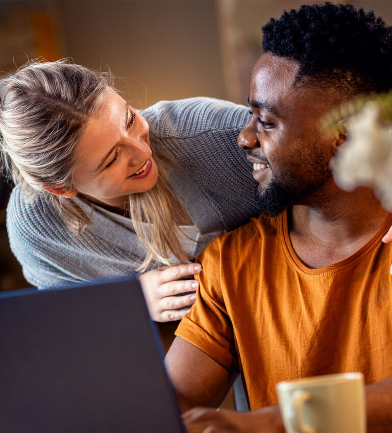 couple smiling at each other during telehealth session